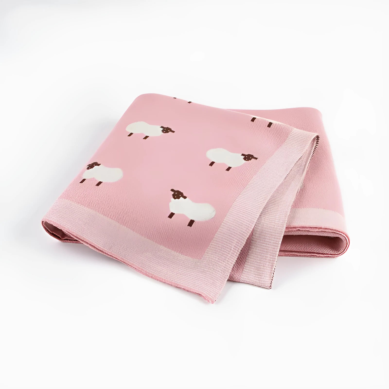 A pink baby sheepskin blanket measuring 100 by 80 cm on a pram.