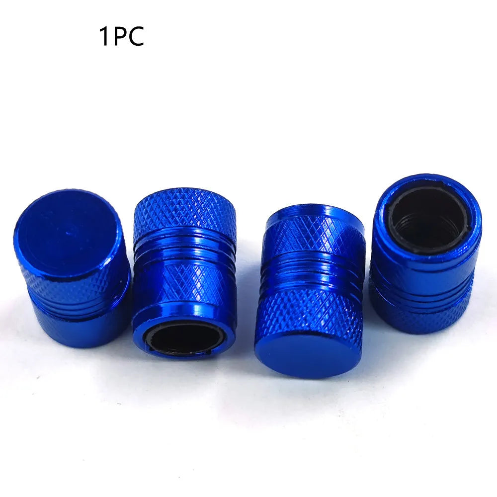 Aluminium car tyre valve dust cap in black, blue, grey, and red colours.