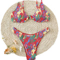 Red floral patterned women's underwire triangle bikini top and briefs set on a white background.