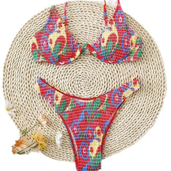 Red floral patterned women's underwire triangle bikini top and briefs set on a white background.