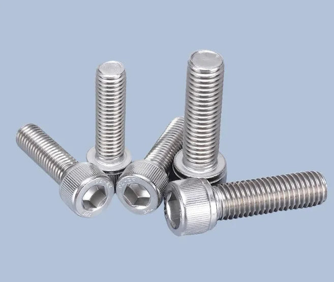 Stainless steel turntable cartridge mounting kit with allen bolts, nuts, washers, and two allen keys on a dark surface.