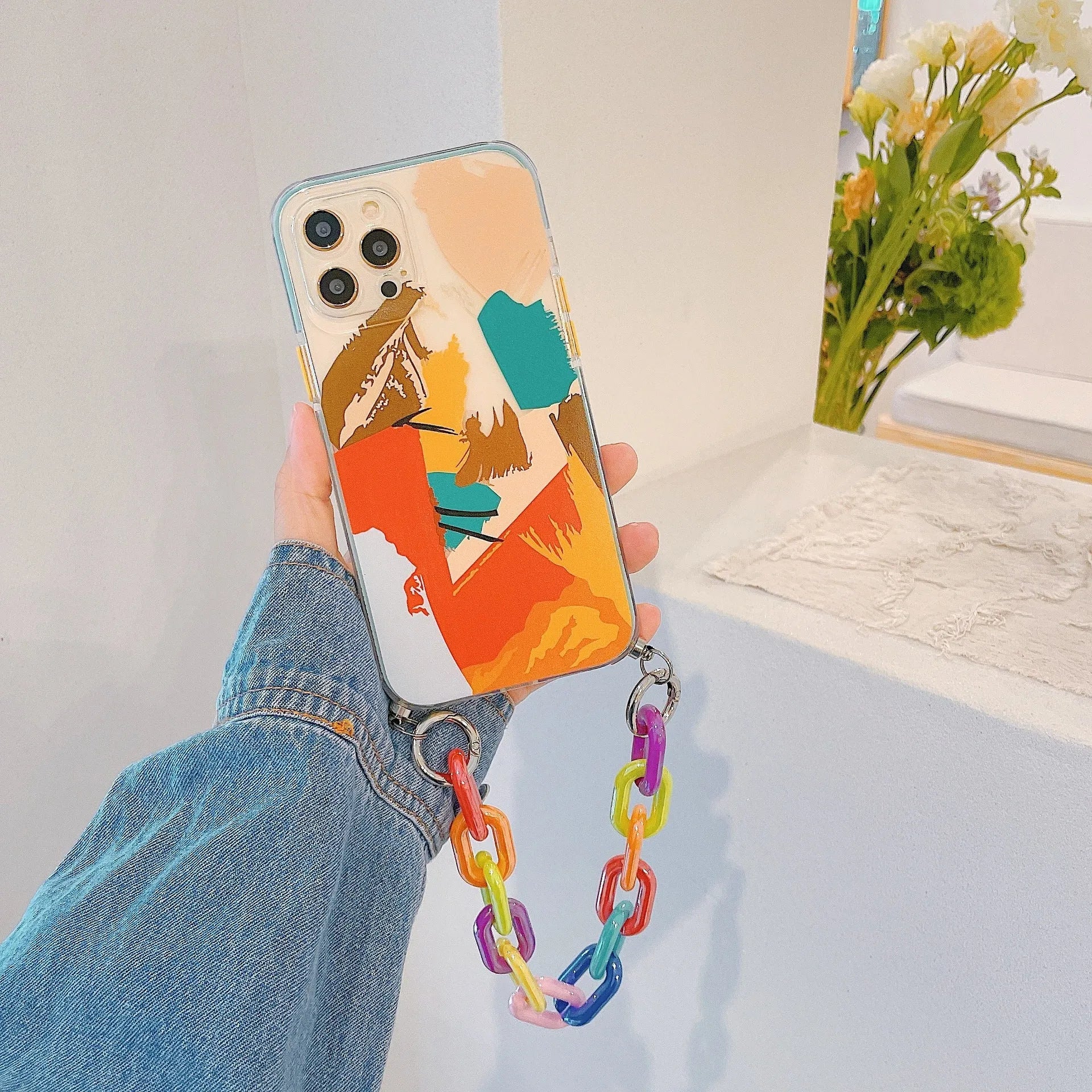 Pink graffiti design mobile phone case with an integrated wrist strap for iPhone.