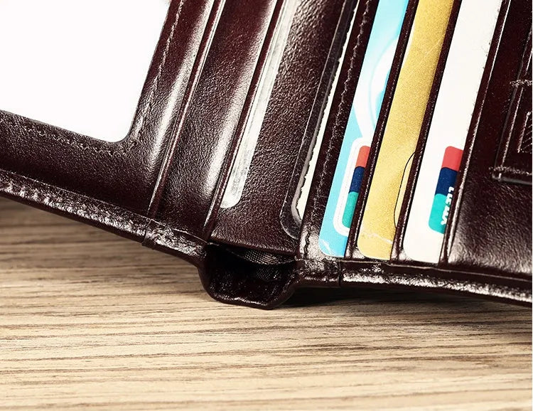 Men's black leather RFID blocking wallet open to show card slots, ID window, and coin pocket.