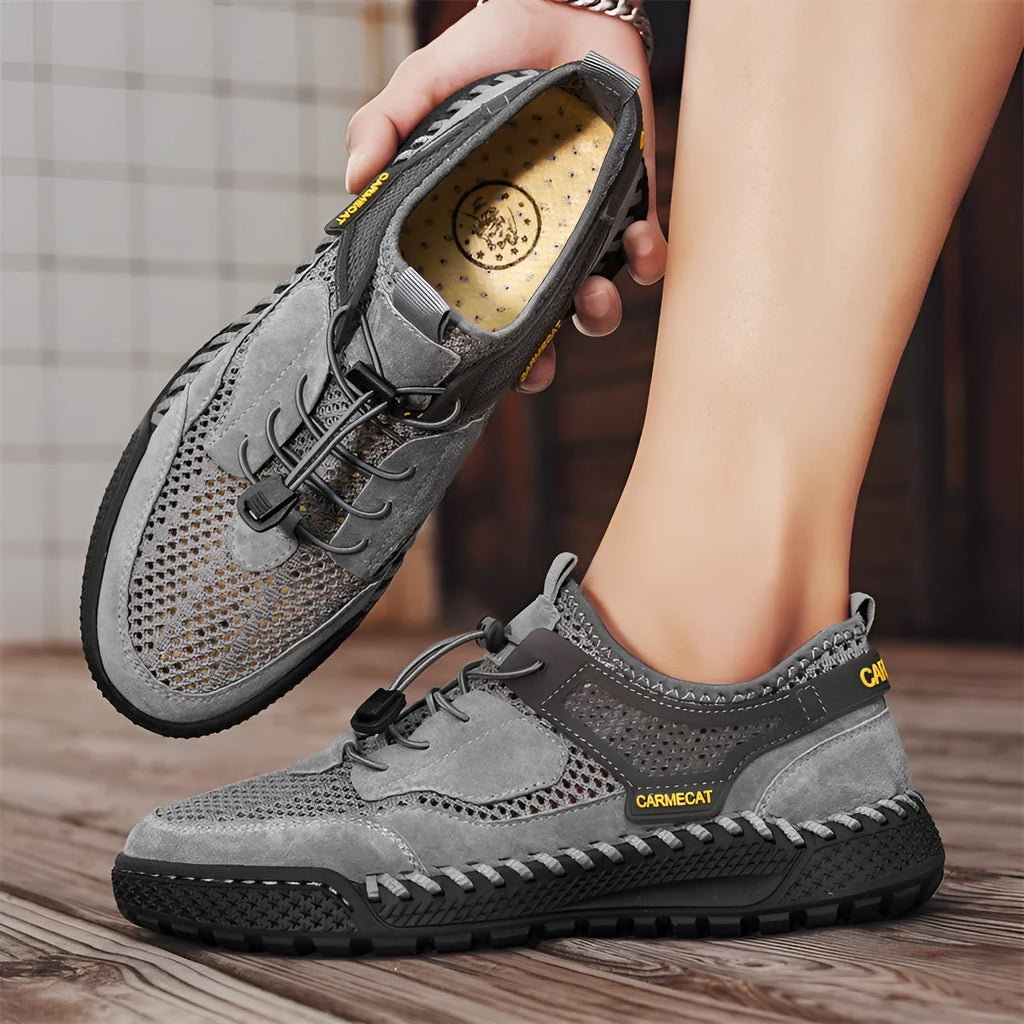Men's grey suede low-top trainers with elastic band and hand-stitched rubber sole.