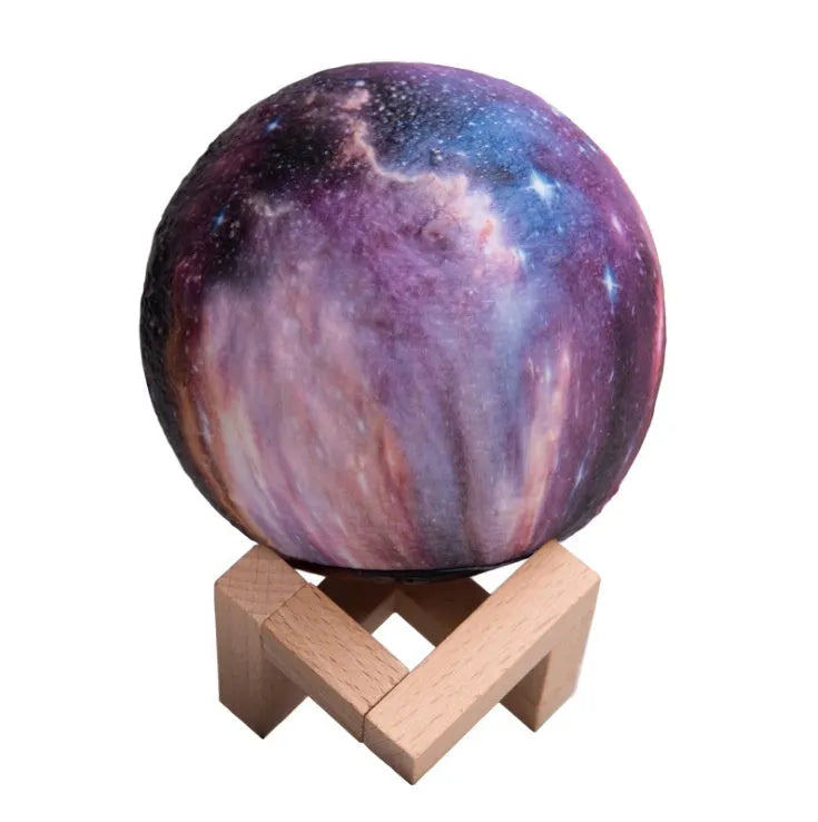 3D printed spherical lunar lamp with colour changing LED light on a surface.