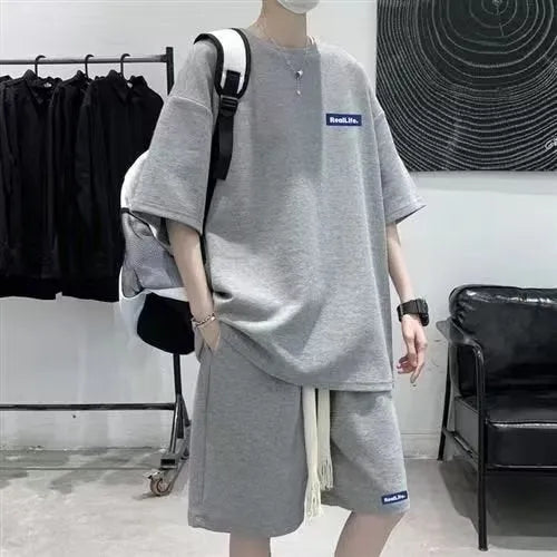 Men's cotton polyester waffle texture short sleeve top and shorts leisure sports suit set on a hanger.