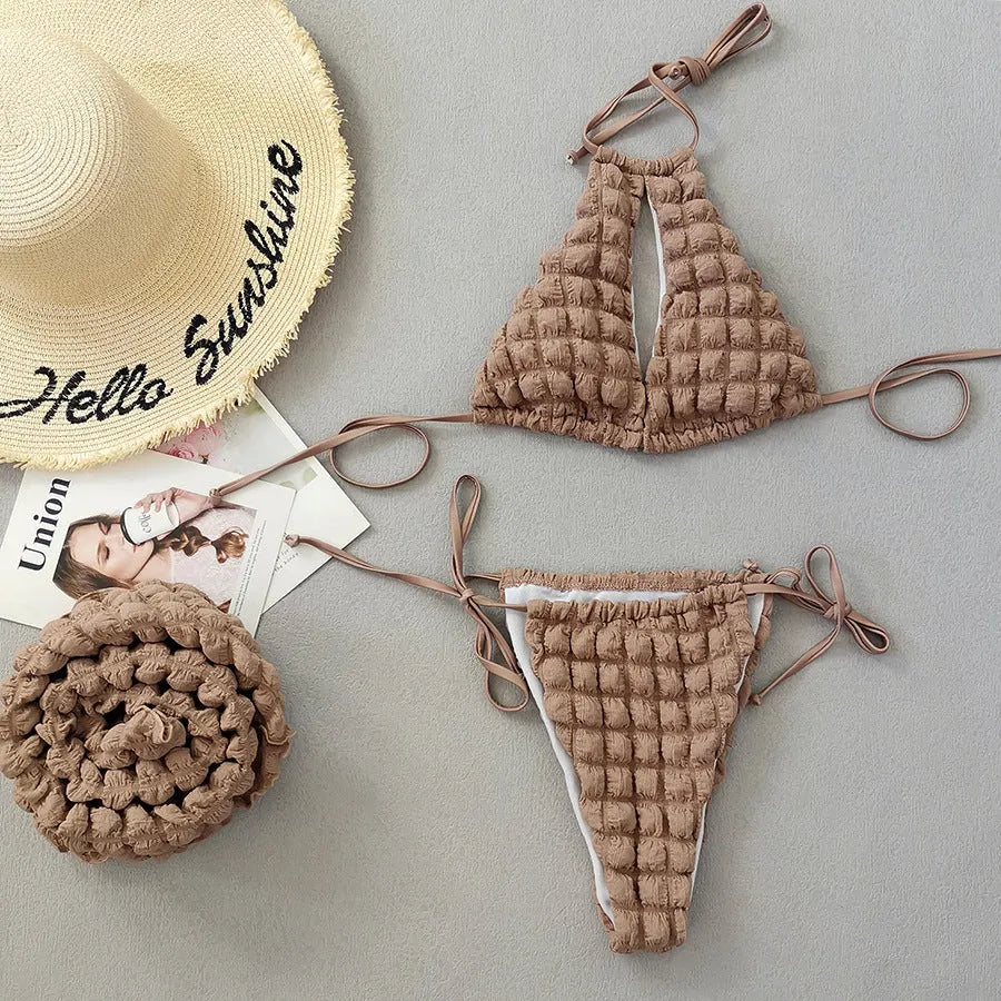 Brown seersucker lace-up three-piece bikini swimsuit for women laid flat, showing top, pants, and skirt.