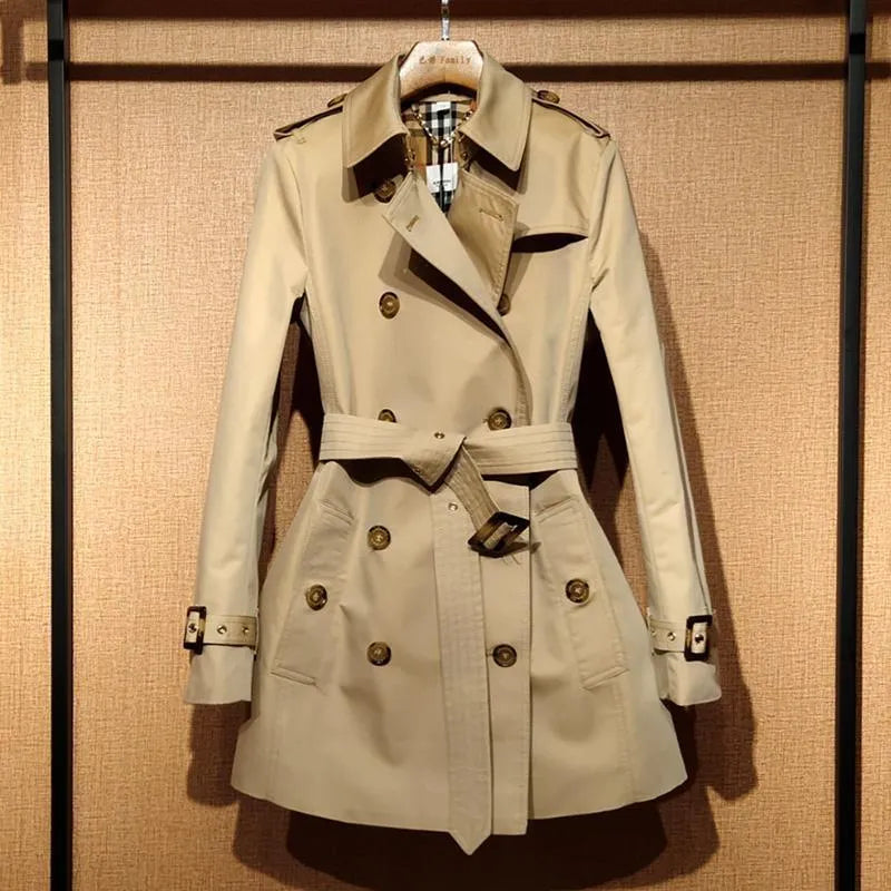 Women's khaki trench coat with double-breasted front and flight sleeves on hanger