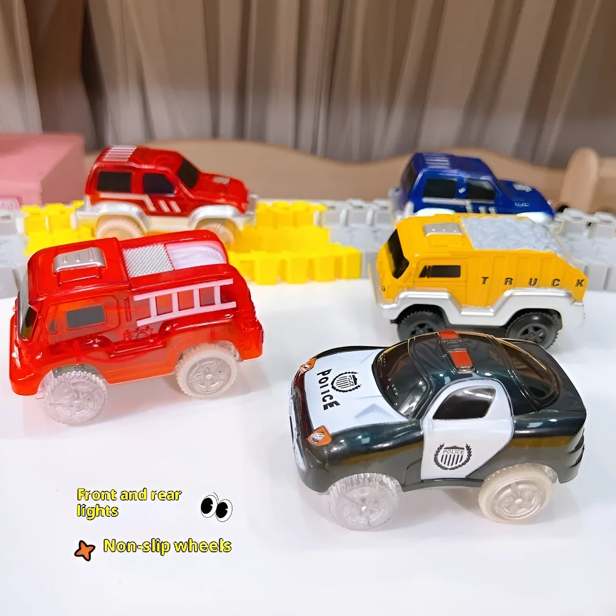 Red electric fire truck rail car with front and rear lights on toy track