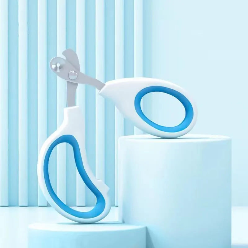 Blue pet nail clippers with a circular guide hole and cushioned handles on a white surface.