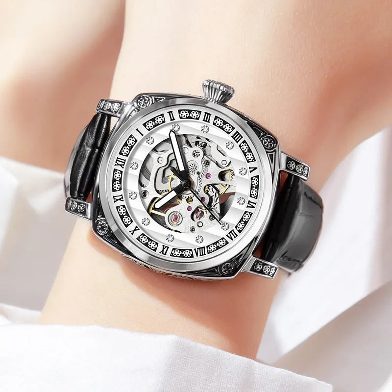 Men's mechanical watch with luminous hands and a black leather strap showing analogue dial.