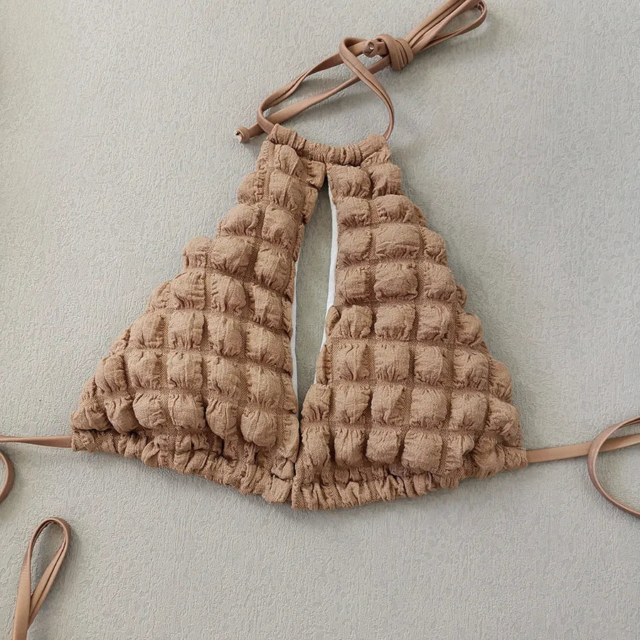 Brown seersucker lace-up three-piece bikini swimsuit for women laid flat, showing top, pants, and skirt.
