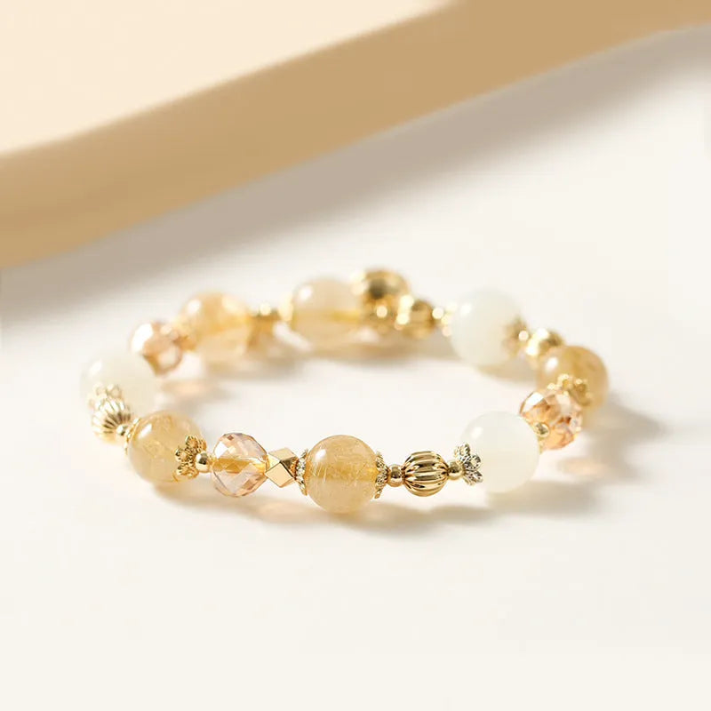Korean style gold bracelet with rutilated quartz crystal charms on an electroplated chain.