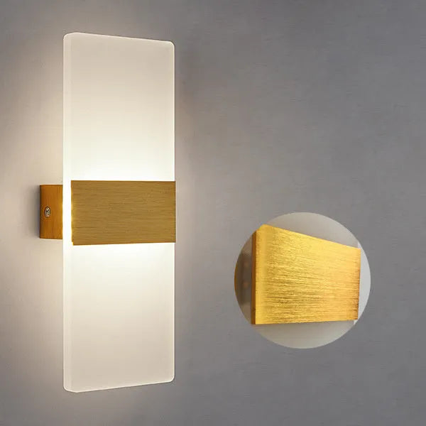 Modern black acrylic LED wall lamp with warm white light on a corridor wall.