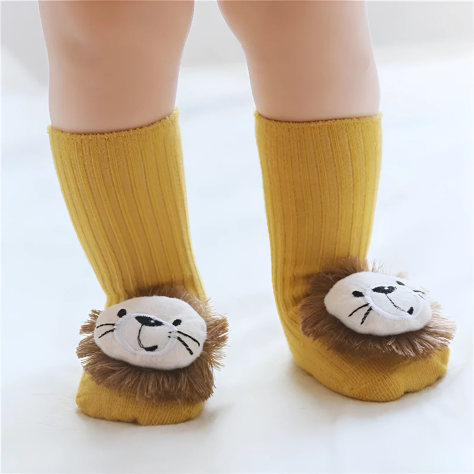 Cotton baby floor socks in a pink bow pattern, shown on an infant's feet.