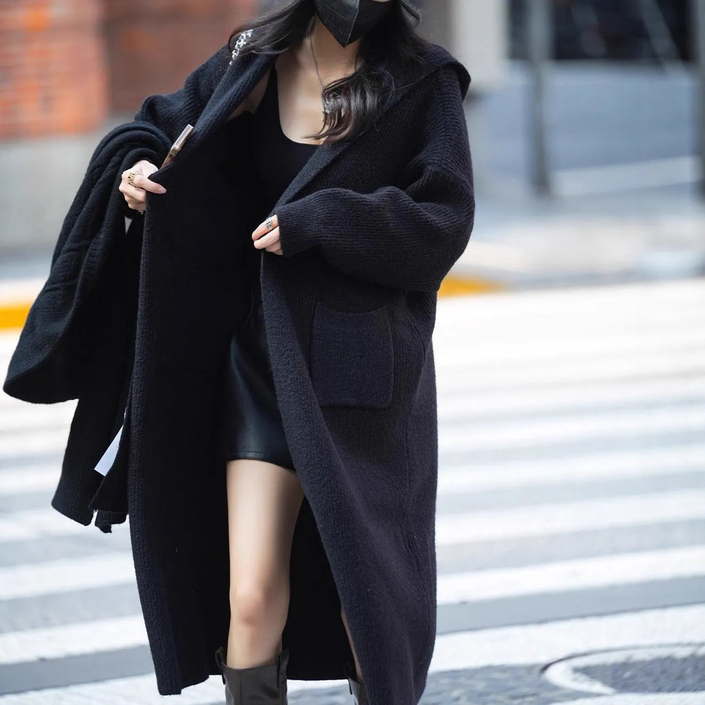 Long grey knitted hooded cardigan coat with a trench coat style, shown open.