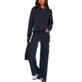 Women's black polyester leisure sportswear set featuring a long sleeve top and matching trousers on a hanger.