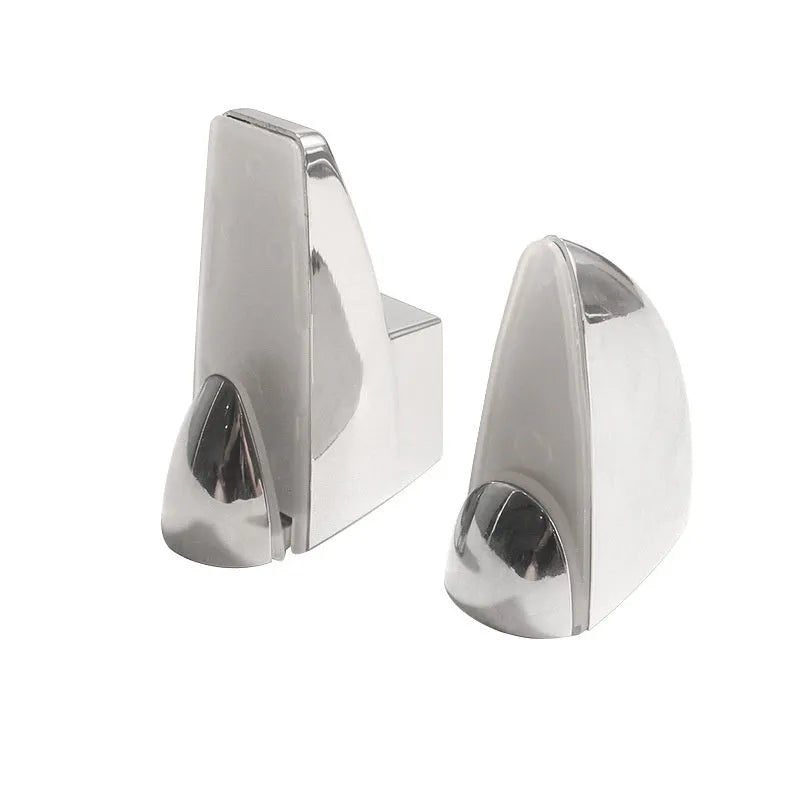 Set of silver electroplated adjustable partition clips in fish mouth and olecranon styles on a glass surface.