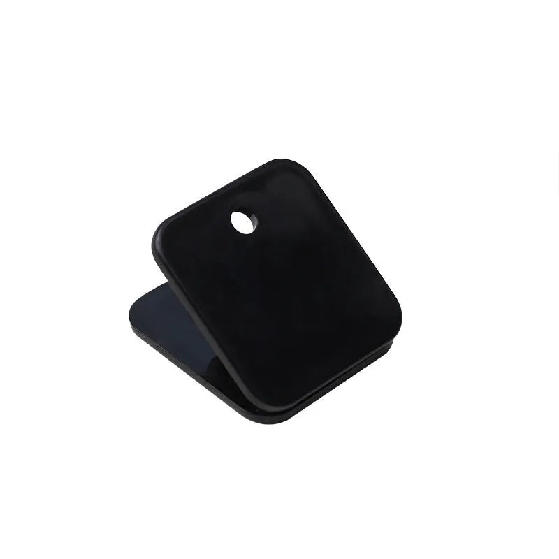 Small square plastic photo note holder in white, black and transparent colours on a desk