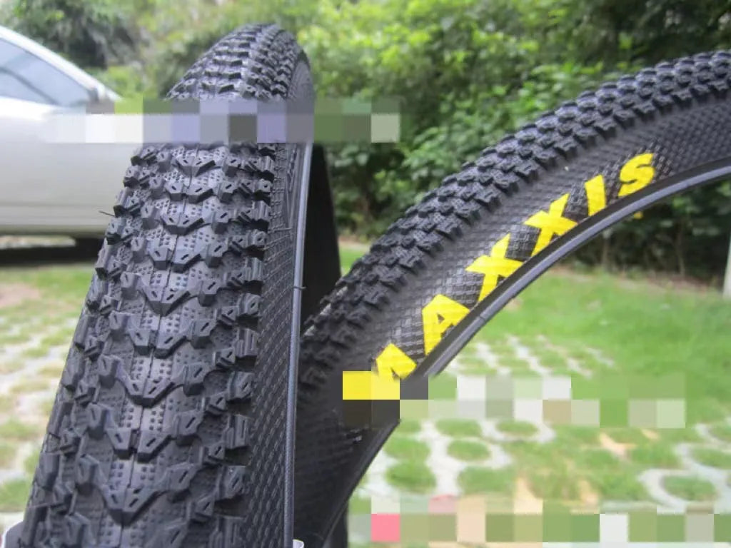 Ultralight mountain bike tyre with reinforced black sidewall shown next to size and weight specifications.