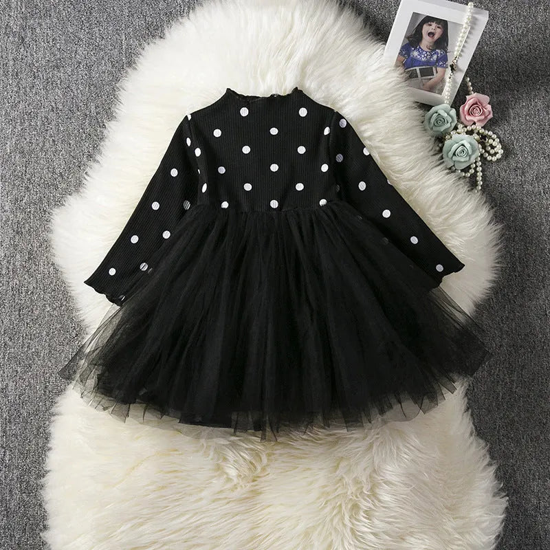 Baby girl in a long sleeve white lace tutu dress for a christening or birthday party.