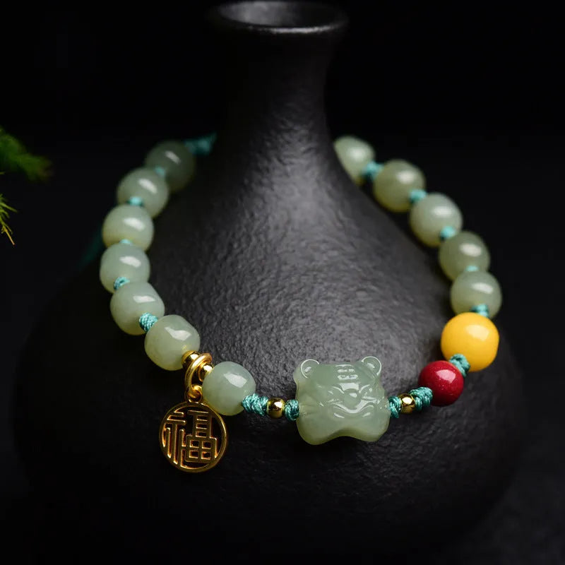 Natural Hetian jade bracelet with zodiac modelling, cinnabar and beeswax beads, and sequin detail.