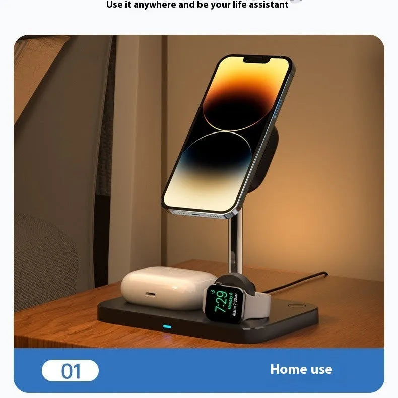 Black magnetic three-in-one wireless charger and cooling bracket on a desk, with phone upright and watch on base.