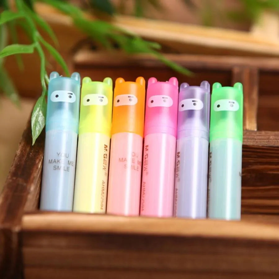 Set of six plastic highlighter pens in different colours with oblique pen shapes