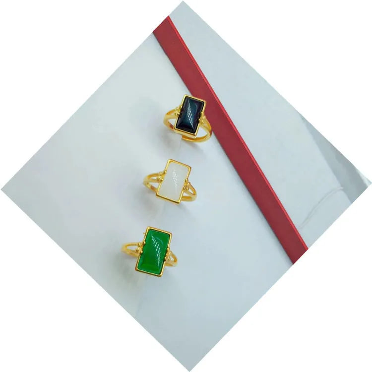 Adjustable brass gold-plated ring with a long green gemstone in a national style setting.