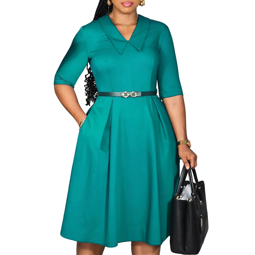 Solid colour African dress with half sleeves and a matching belt, shown on a hanger.