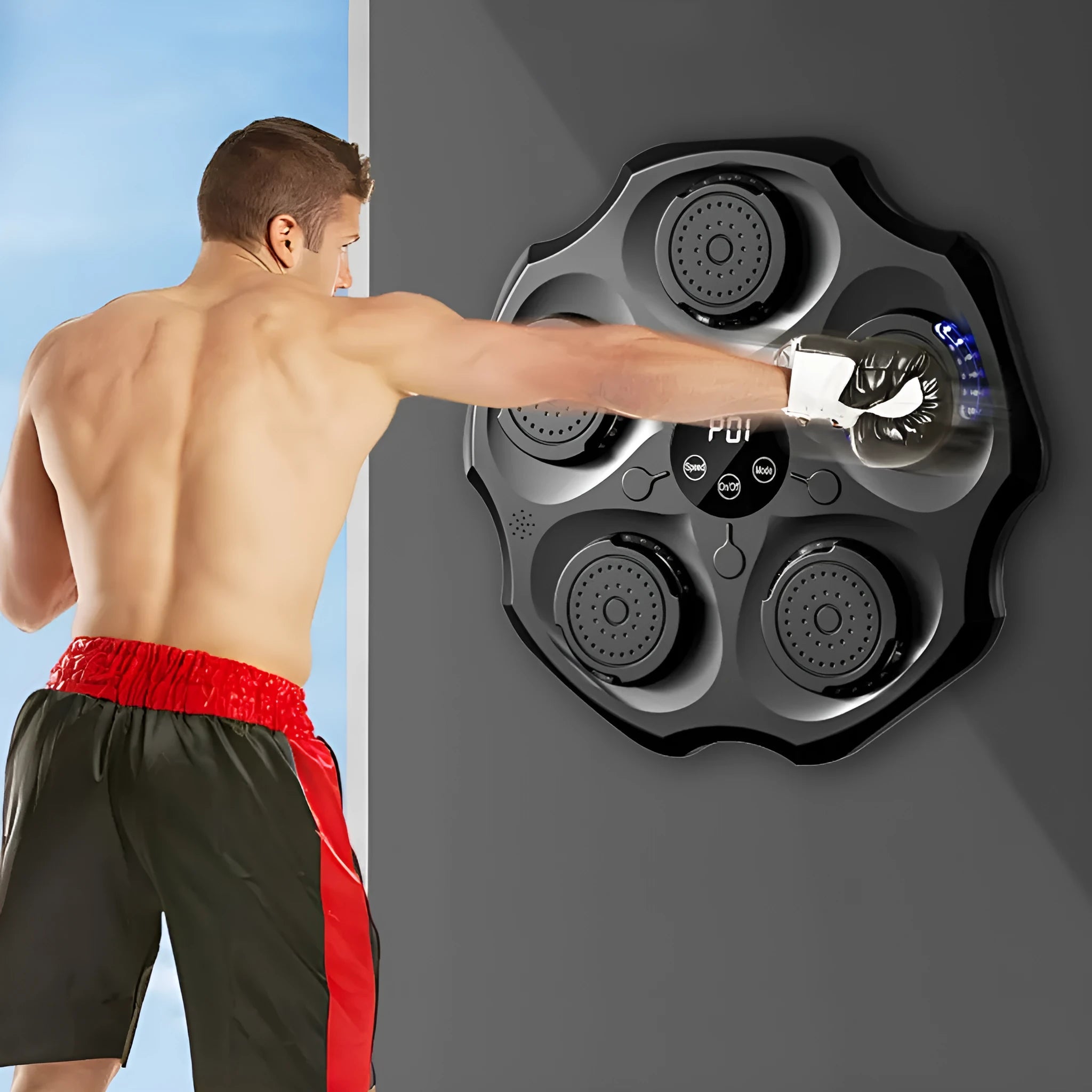 Hanging black Bluetooth music boxing wall target with a single red boxing glove mounted on a home wall.