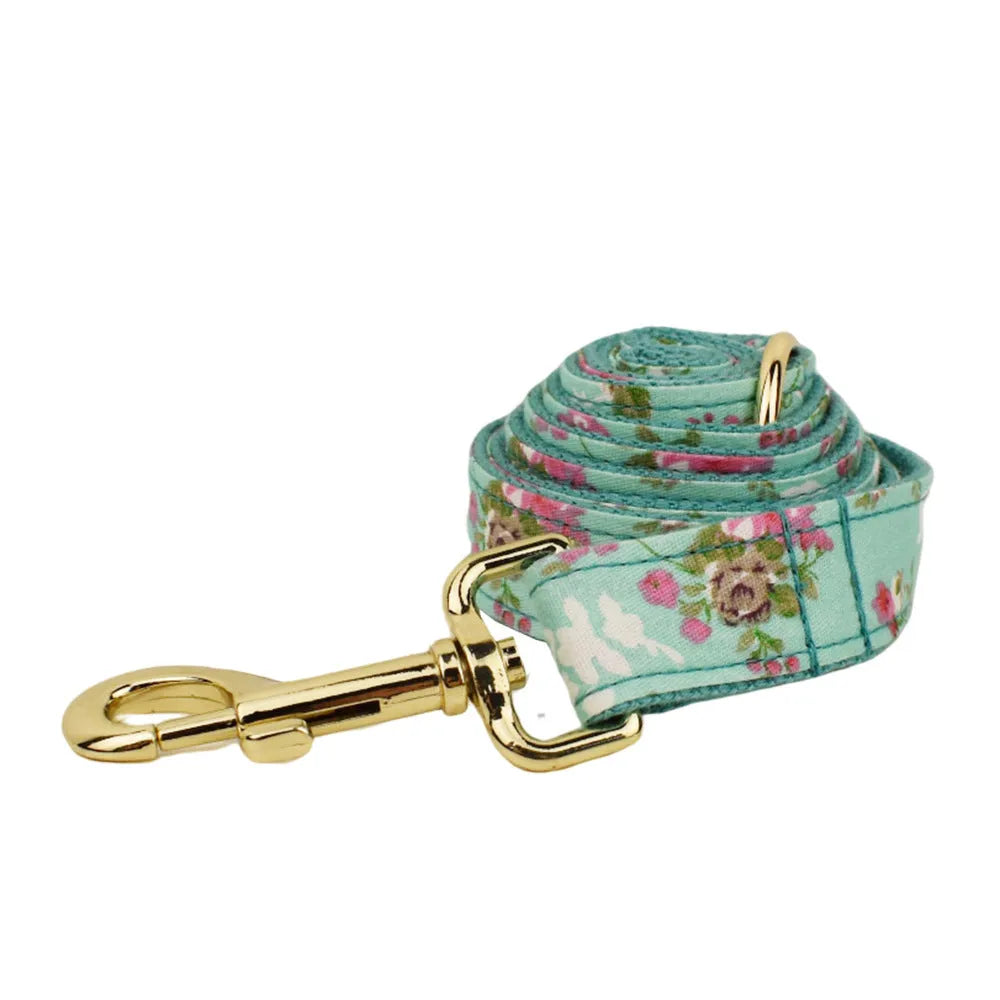Rose pattern dog collar set on green background with detachable bow and matching leash