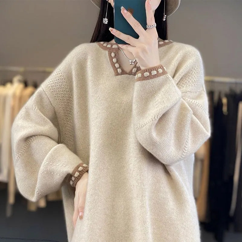 Women's camel V-neck long sleeve viscose sweater laid flat.