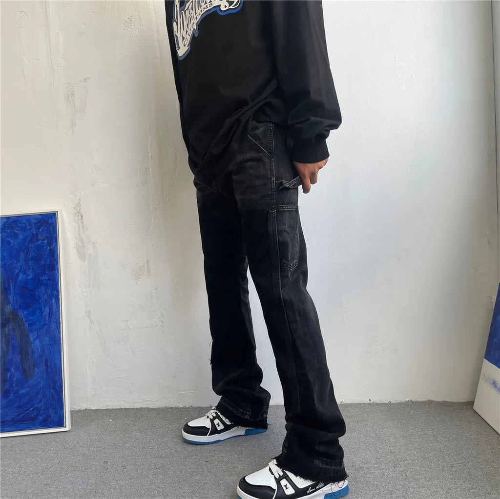 Black micro flared patchwork raw edge jeans on model showing loose straight tube fit
