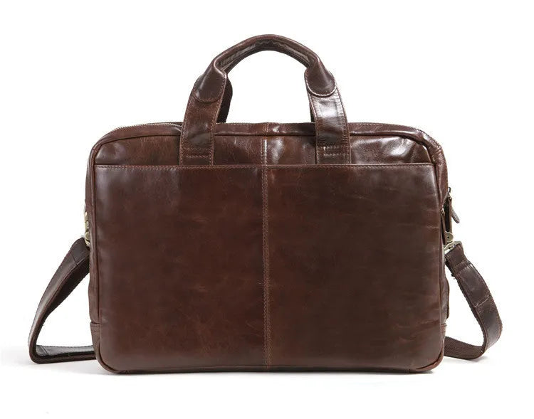 Brown cowhide leather business briefcase open showing interior polyester cotton lining and 18-inch laptop storage