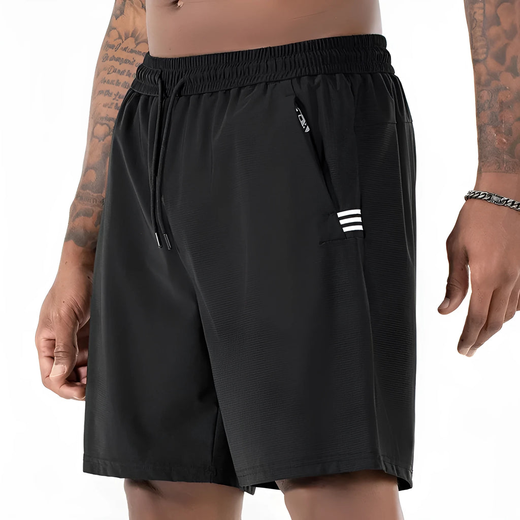 Man wearing black Ice Silk nylon sports shorts with a drawstring waist and cropped leg.