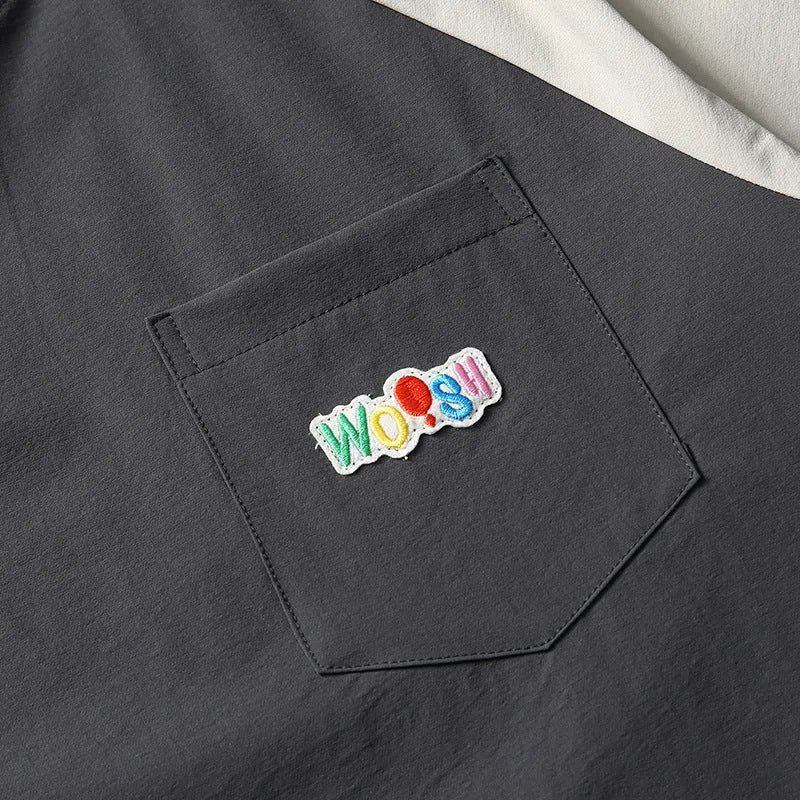 Dark grey men's loose fit t-shirt with contrasting raglan sleeves on a hanger.