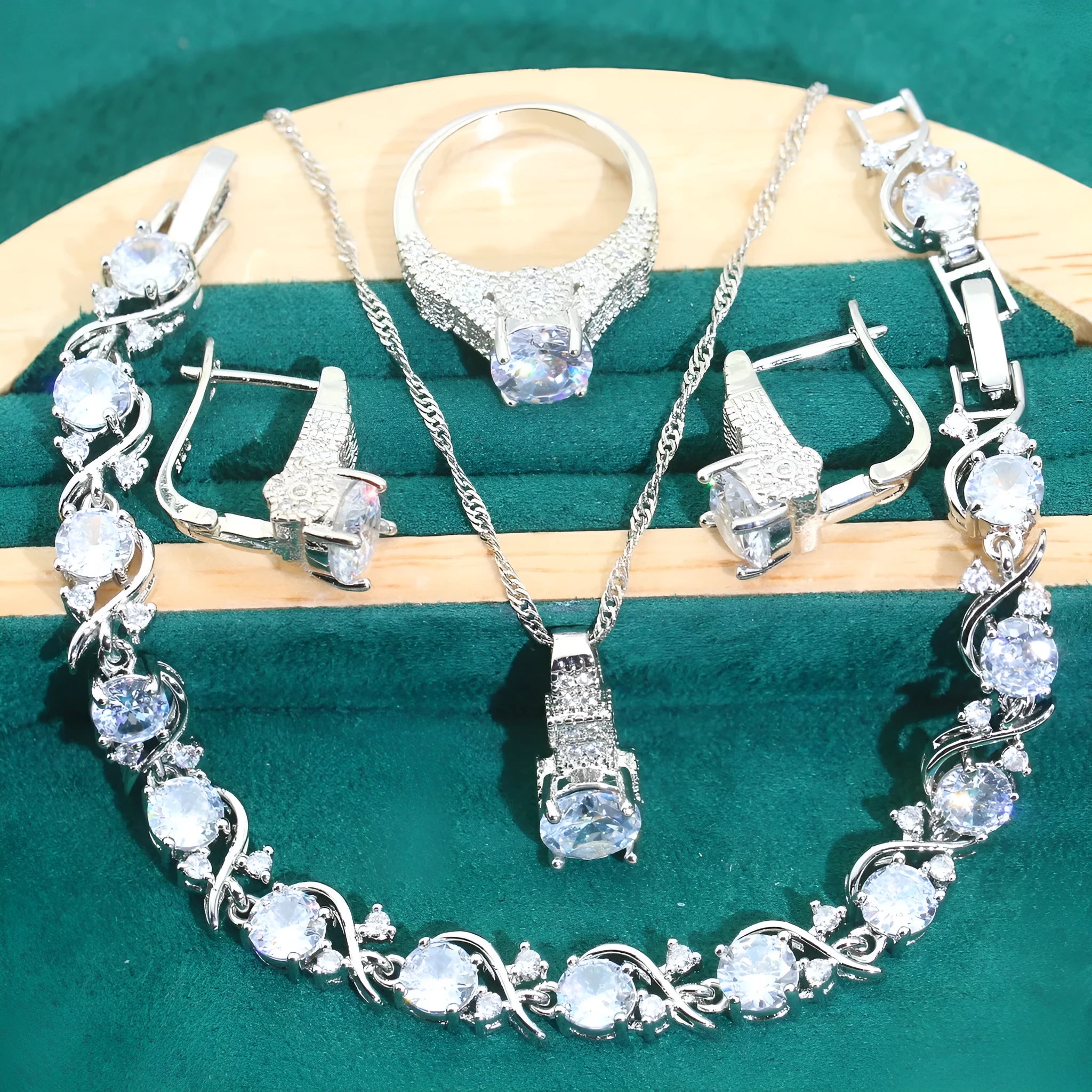 Four-piece bridal zircon jewellery set showing necklace, bracelet, earrings, and ring in a choice of colours.