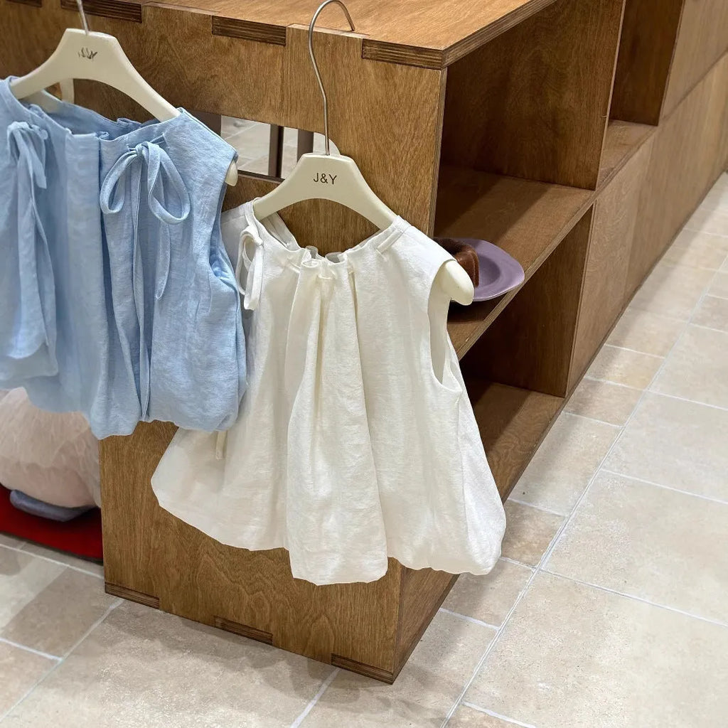 Milky white Korean style cotton drawstring shirt for girls with sleeveless design on light background
