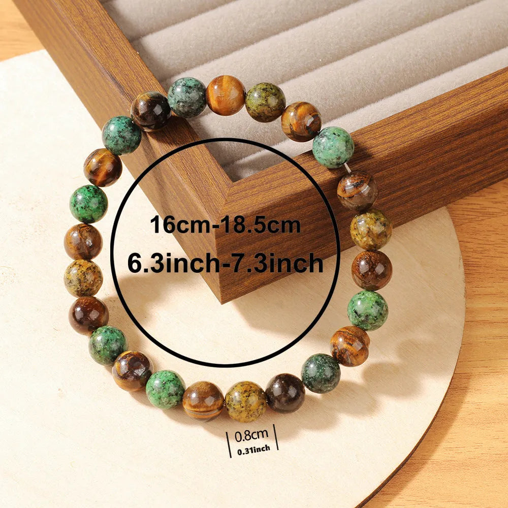 Handmade tigereye stone bracelet with 18mm flower-design beads on an adjustable strap.