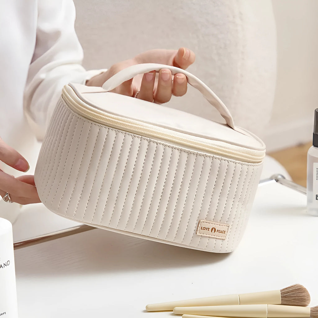 Open-top women's makeup bag in solid-colour PU leather, shown in beige.