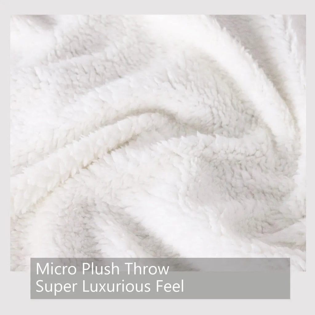 Pink Sherpa fleece dog themed throw blanket on sofa with hemmed edges