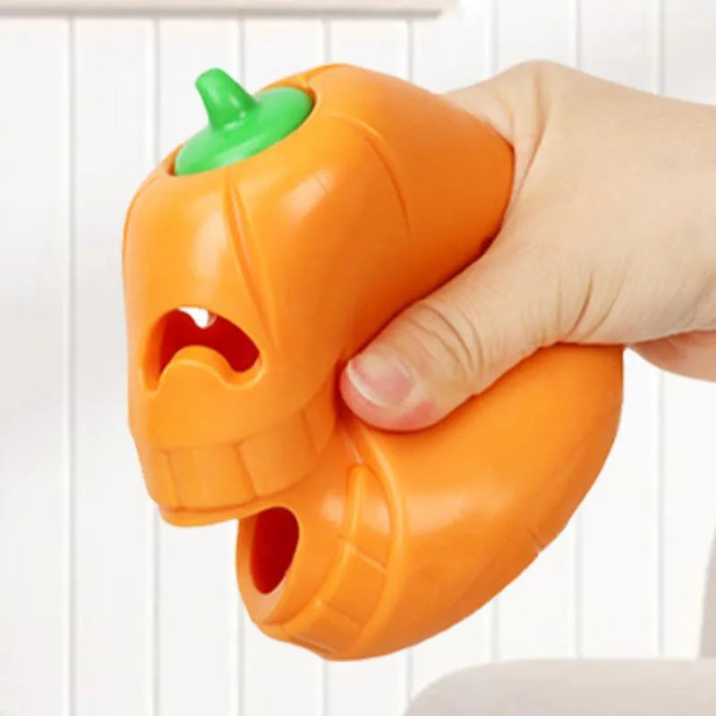 Yellow pumpkin-shaped tough TPR chew toy for dogs on a white background.