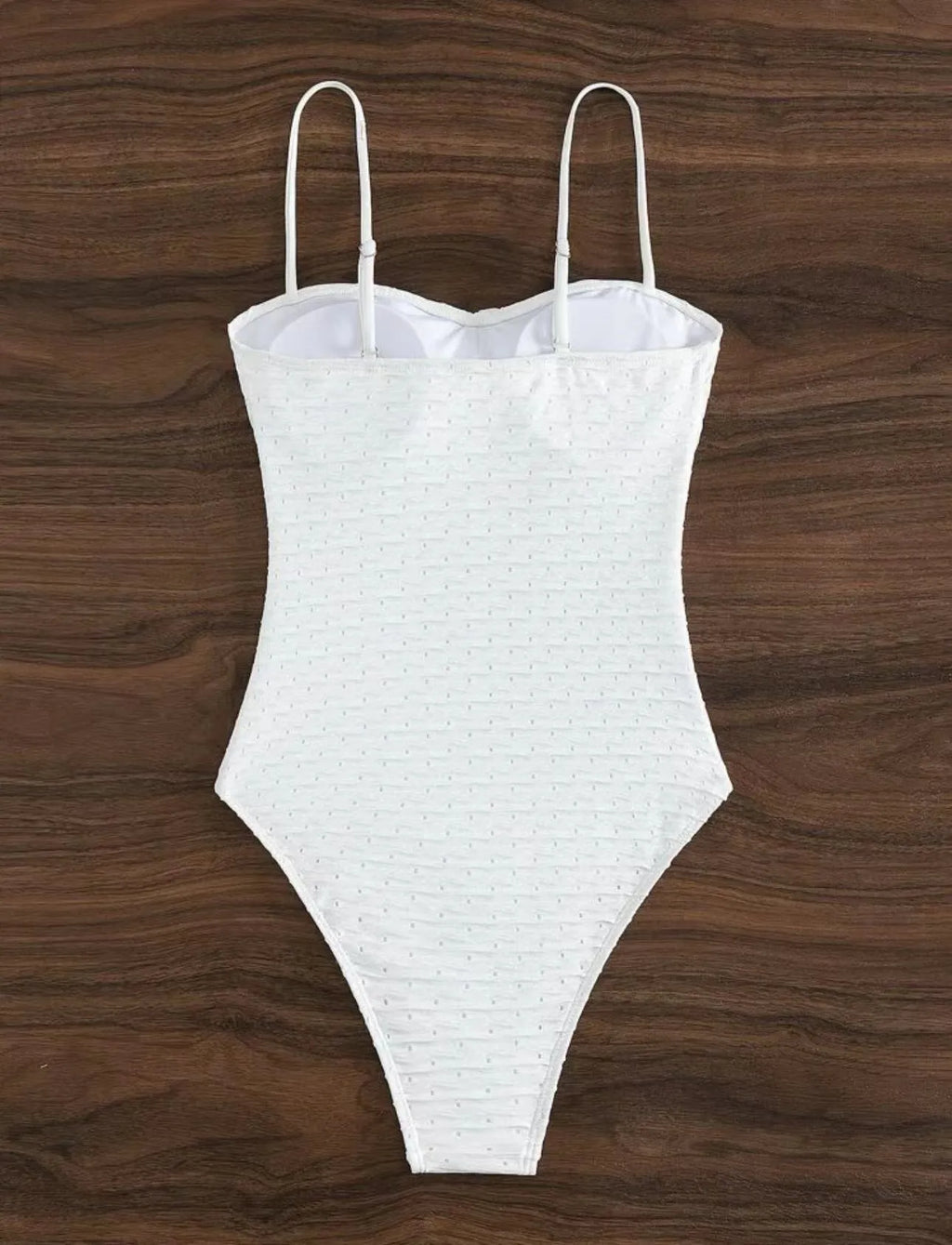 White one-piece swimsuit for women with sling back and briefs cut on a mannequin