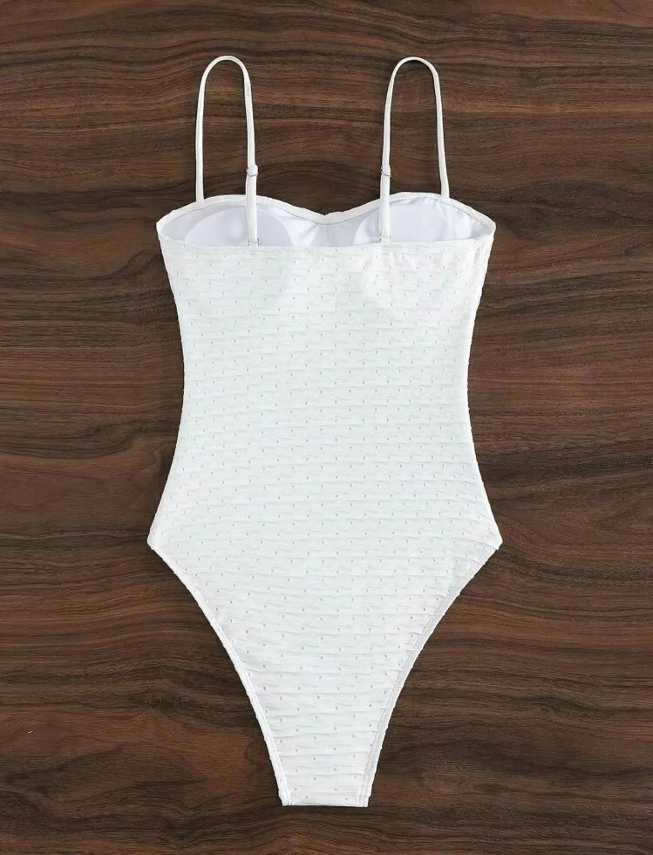 White one-piece swimsuit for women with sling back and briefs cut on a mannequin