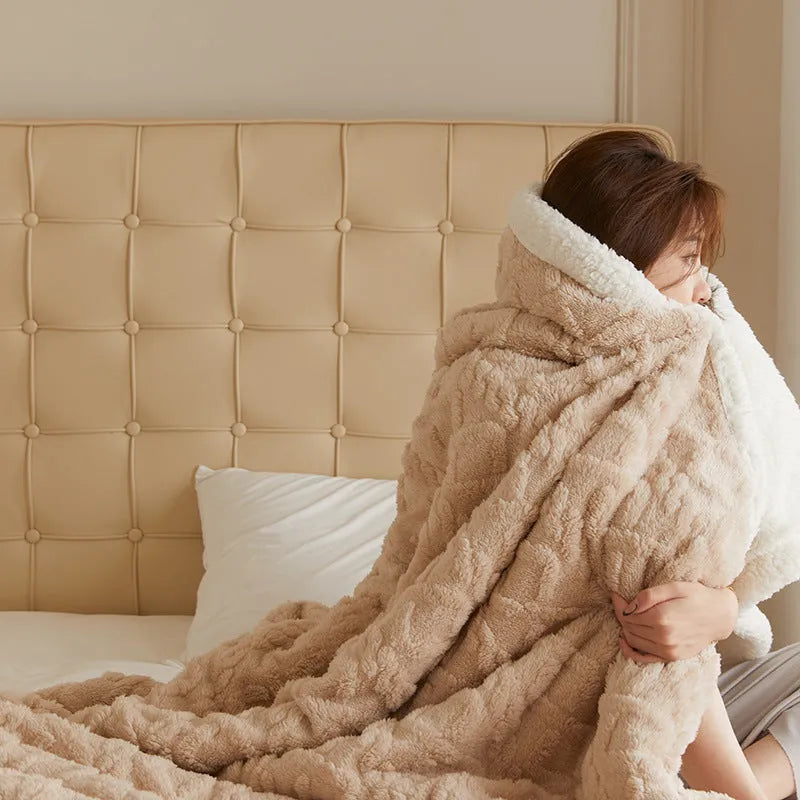 Taffeta thermal flannel winter blanket in beige draped over a modern sofa.
