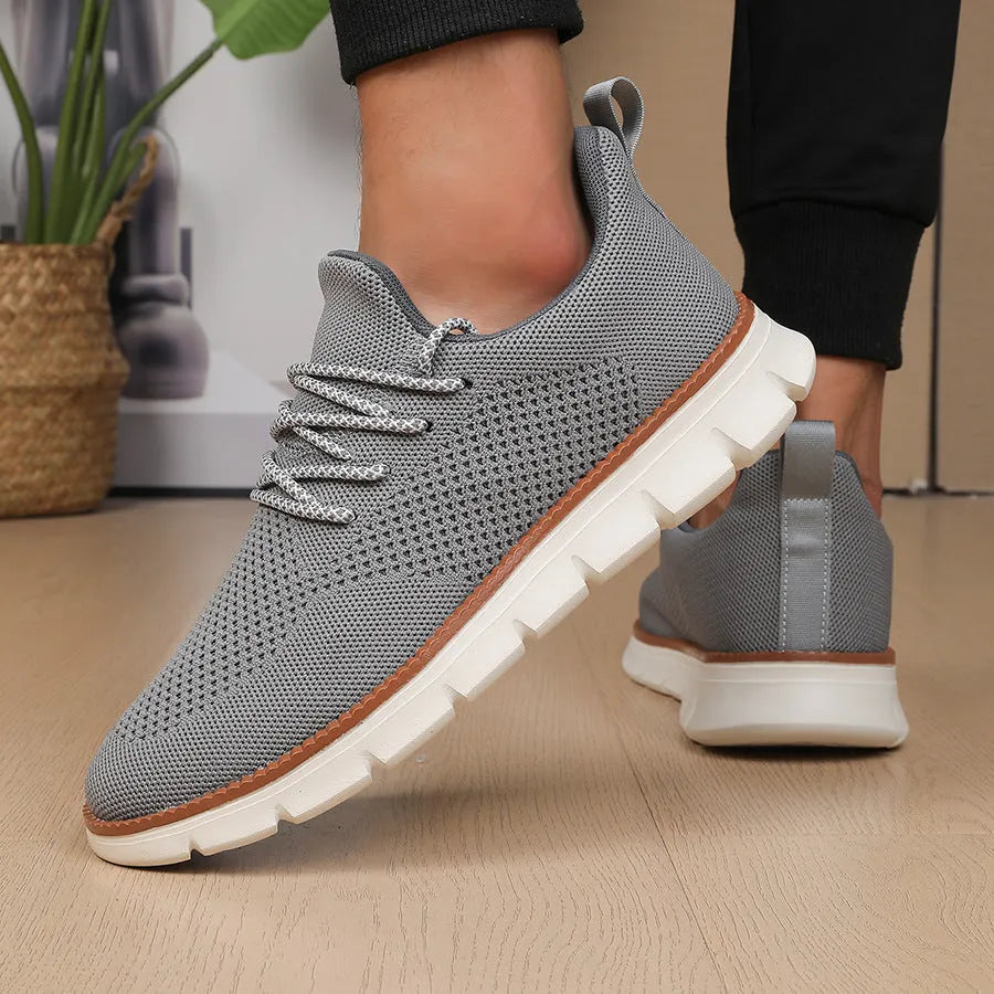 Men's grey and black casual sneakers with woven mesh upper and round toe.