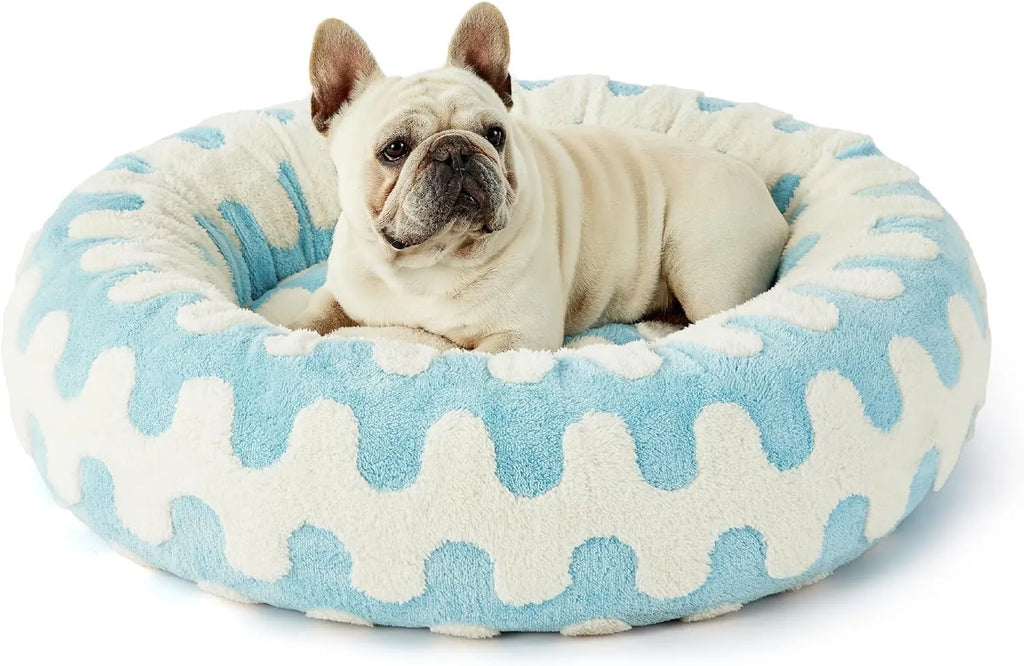 Round plaid dog bed with a plastic base shown in blue and white colours.