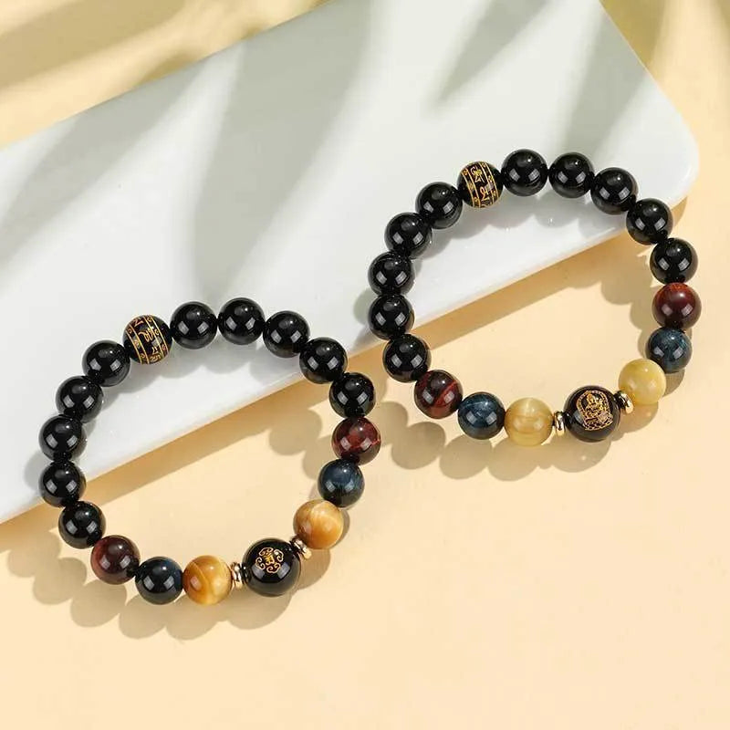 Handmade black agate bracelet with zodiac animal charms and gold tiger eye beads on wrist