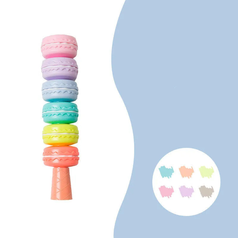 Set of six colourful cookie-shaped highlighter pens with macaron colours arranged on a white surface.